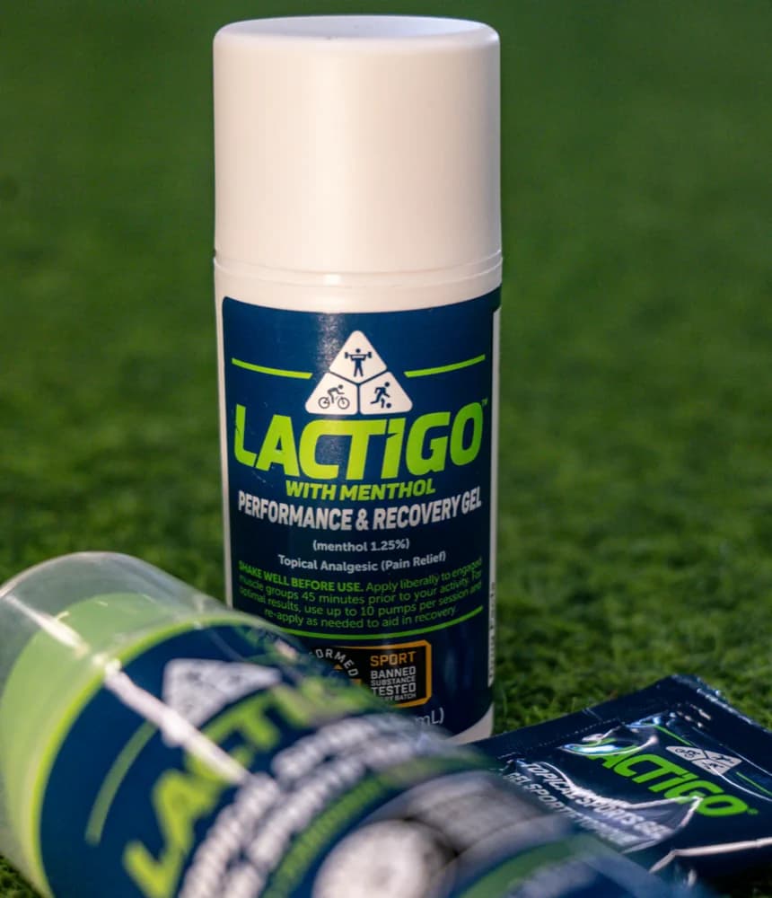 LactiGo Performance and Recovery Gel with menthol, 100 ml pump bottle on a turf pitch